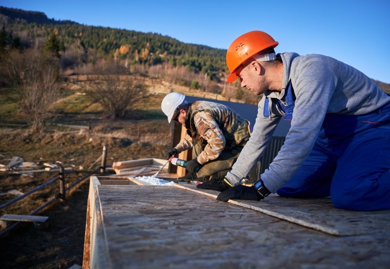 Sky Scape Roof workers doing thermal insulation on a roof